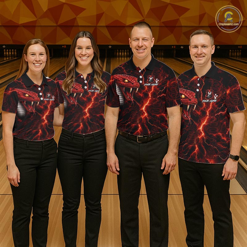 Four people standing in a bowling alley wearing matching black short-sleeve polo shirts with a red and black lava crackle print and a red snake graphic on the chest. The shirts also feature a white logo on the left chest.