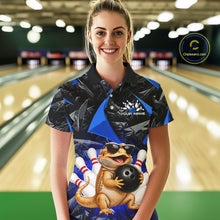 Load image into Gallery viewer, Women’s blue bearded dragon bowling polo shirt, front view on female model in bowling lane 