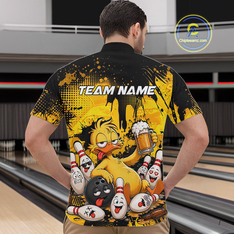 A man viewed from behind wearing a short-sleeve bowling-themed t-shirt with a yellow and black graphic print featuring cartoon bowling characters and pins, set against a bowling alley background.