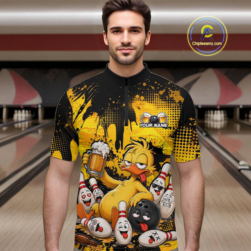 A man wearing a short-sleeve black and yellow quarter-zip cycling jersey with a cartoon graphic of a yellow duck holding a beer mug among bowling pins. The jersey has a placeholder text 'YOUR NAME' on the chest.