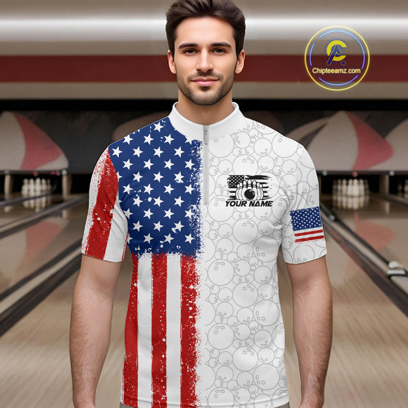 A man wearing a short-sleeve bowling jersey with a split American flag design, standing in a bowling alley. The left side of the shirt features a distressed red, white, and blue American flag pattern, while the right side is white with a subtle bowling ball pattern.