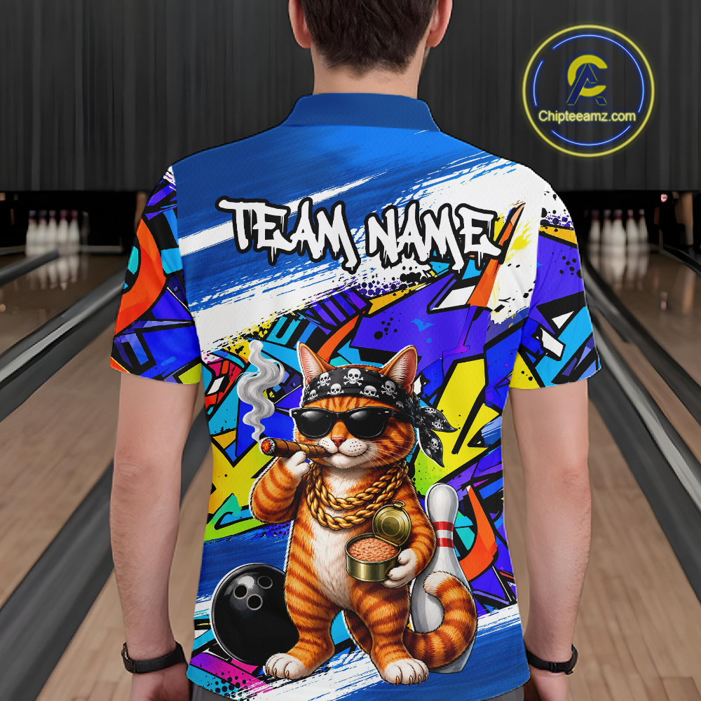 Man wearing a colorful bowling shirt with a cat design in a bowling alley.