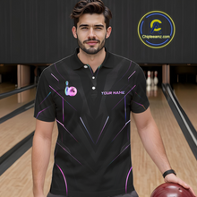Load image into Gallery viewer, Man wearing a black bowling shirt with colorful designs on a bowling alley.