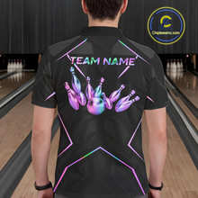 Load image into Gallery viewer, Person wearing a black bowling shirt with colorful design and 'TEAM NAME' text in a bowling alley.