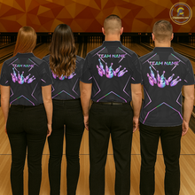 Load image into Gallery viewer, Four people wearing black shirts with colorful designs and 'TEAM NAME' text on a bowling alley.