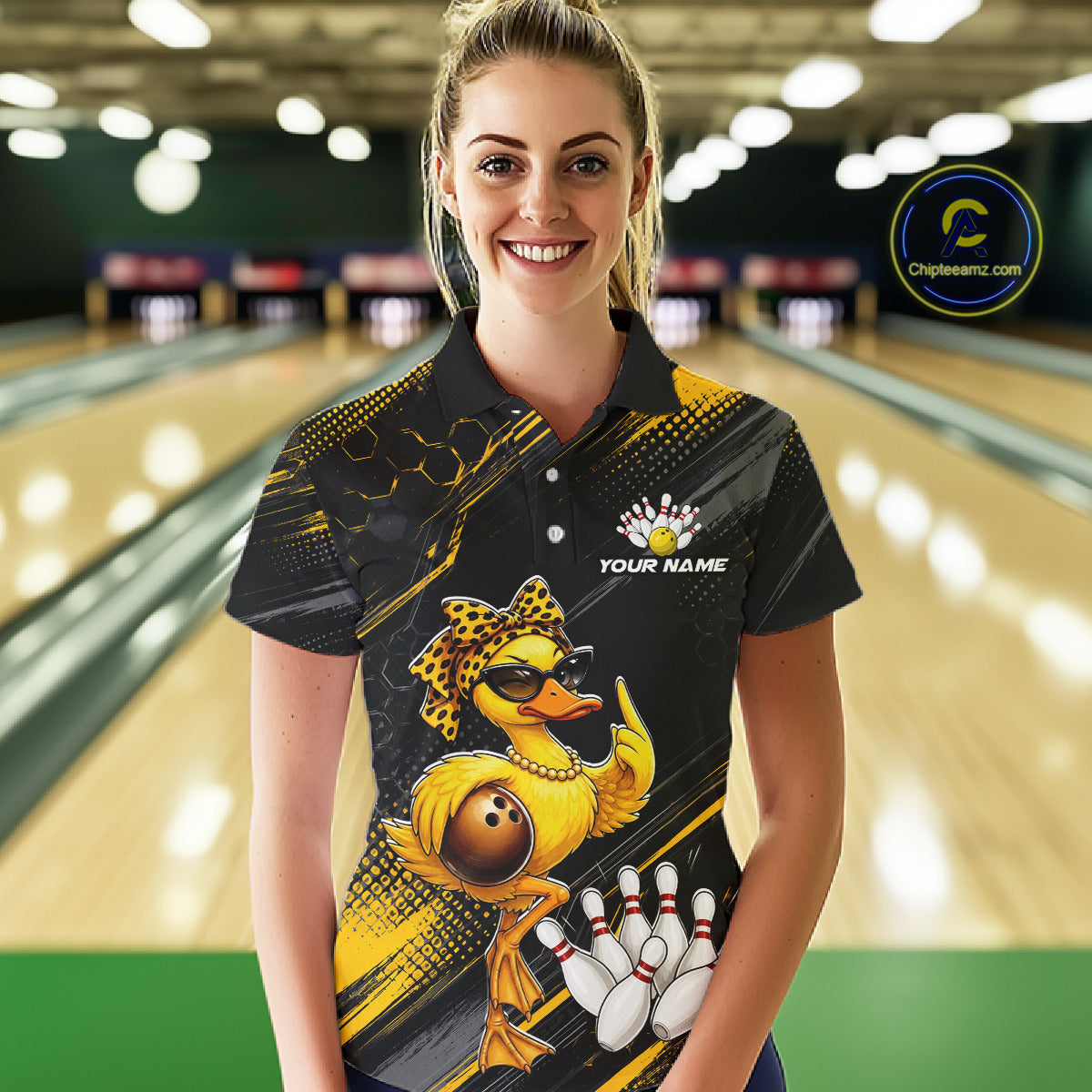 Woman wearing a bowling shirt with a duck design in a bowling alley.