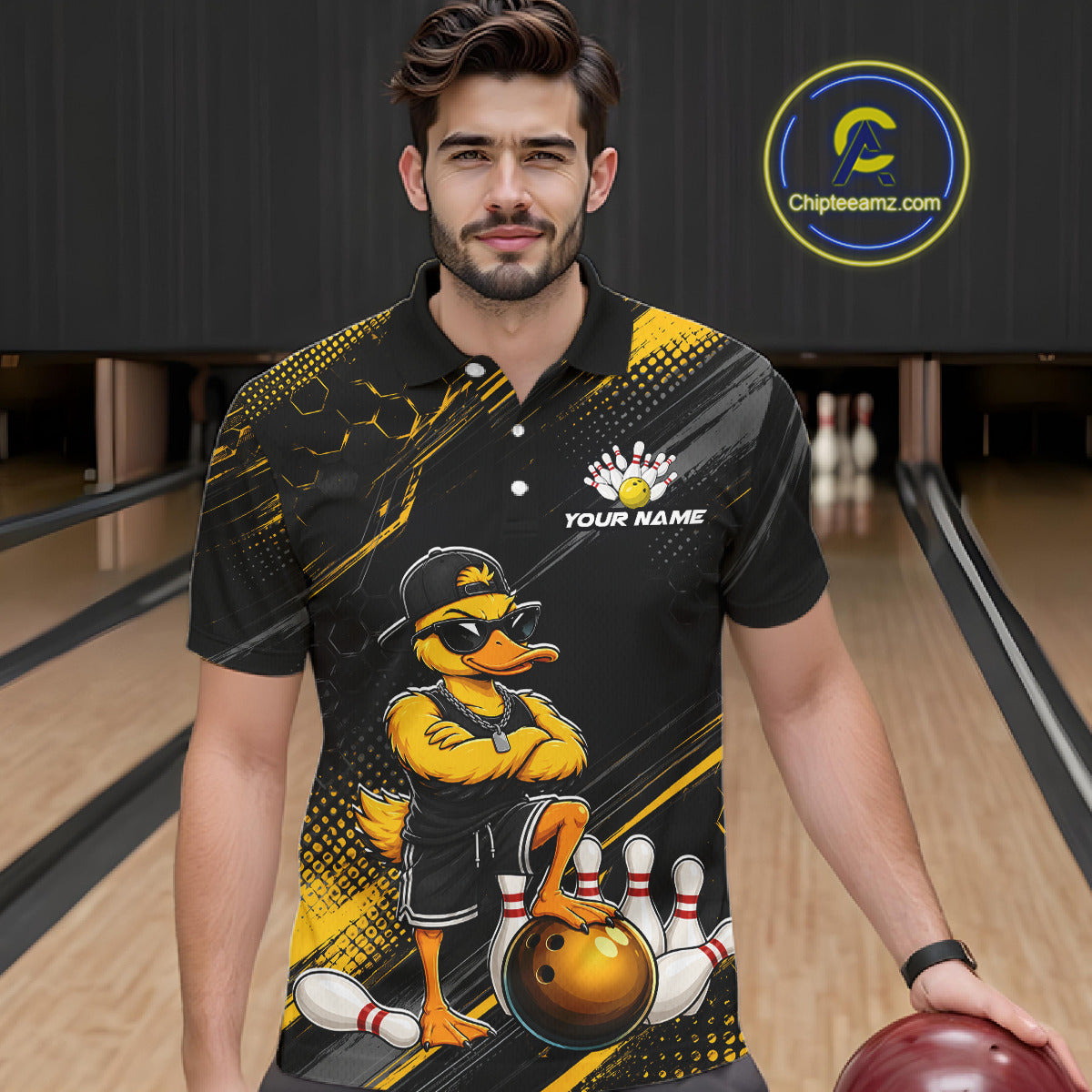 Man wearing a black and yellow bowling shirt with a duck design in a bowling alley.