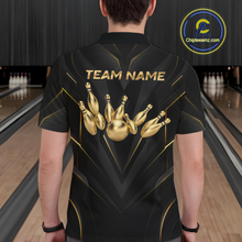 Load image into Gallery viewer, Person wearing a black bowling shirt with gold pins design and 'TEAM NAME' text in a bowling alley.