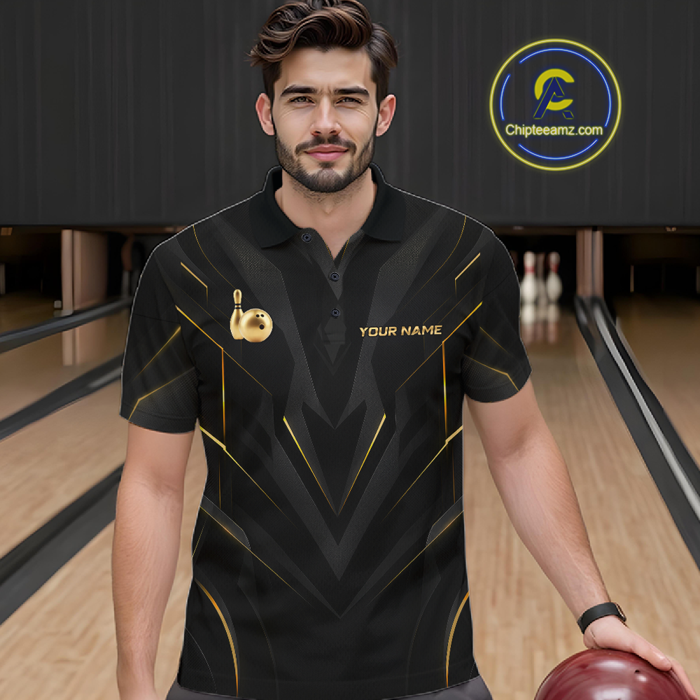 Man wearing a black bowling shirt with gold accents in a bowling alley.