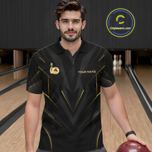 Load image into Gallery viewer, Man wearing a black bowling shirt with gold accents in a bowling alley.