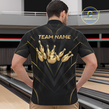 Load image into Gallery viewer, Man wearing a black bowling shirt with gold designs and 'TEAM NAME' text in a bowling alley.