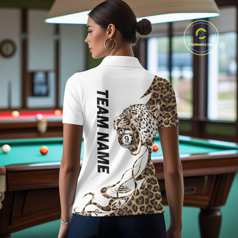 Woman wearing a white polo shirt with a leopard design and 'Team Name' text, standing in a pool hall.
