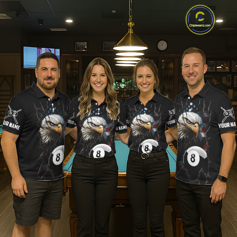 Four teammates in a billiards hall wearing matching black eagle-themed pool polos with cracked flag artwork, sleeve name text, and large 8-ball graphics.