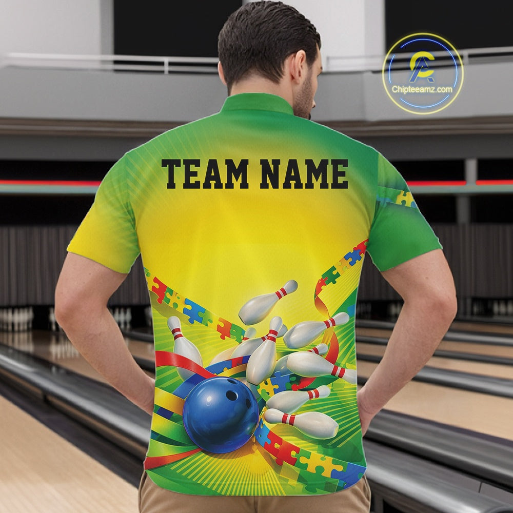 Male model in a bowling lane wearing a green and yellow quarter-zip shirt, puzzle bowling strike artwork with energetic autism-themed design.