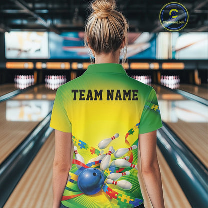 Back view of a female bowler wearing a green and yellow quarter-zip shirt, puzzle bowling ball and pins illustration with colorful autism awareness theme.