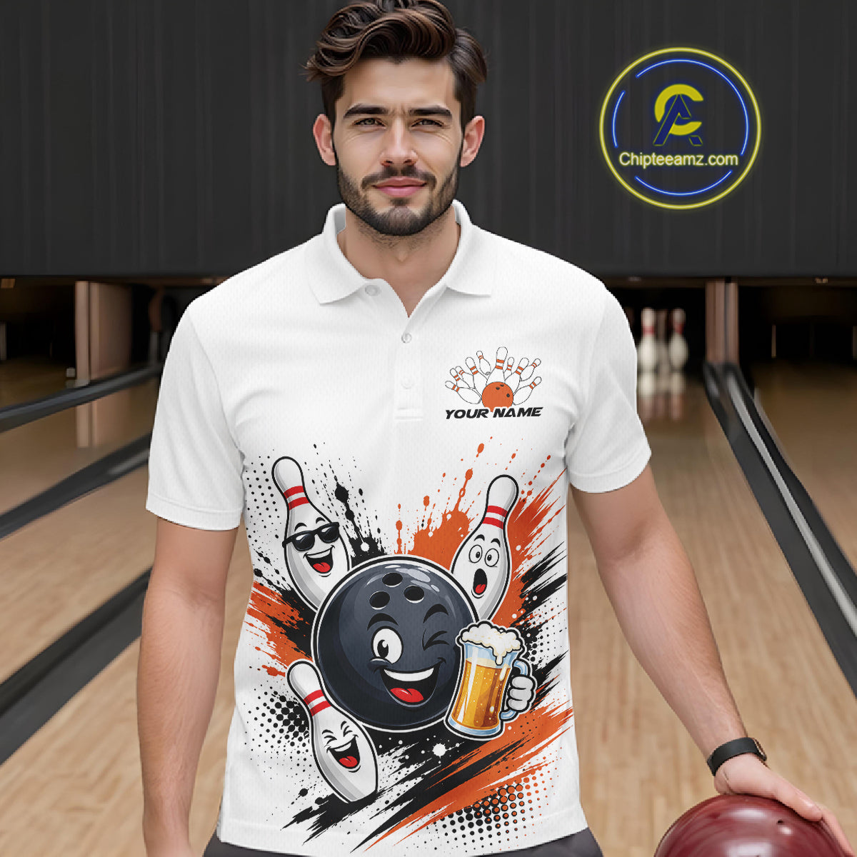 A man wearing a white short-sleeve polo shirt with a bowling-themed graphic print featuring a cartoon bowling ball, pins, and orange paint splatters. He is standing in a bowling alley holding a bowling ball