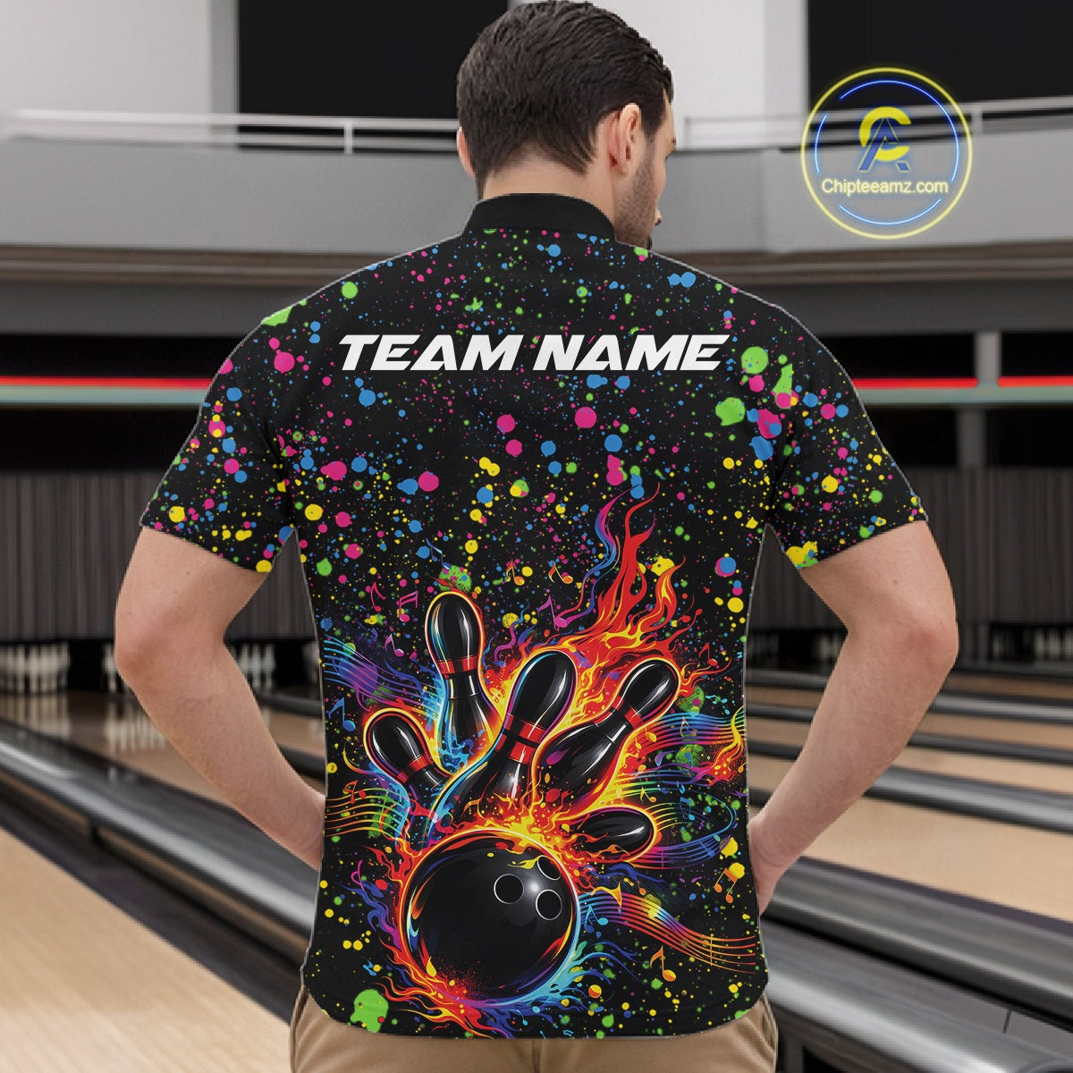 Front view of a male model in a black bowling quarter-zip shirt featuring colorful paint splatter bowling graphics.