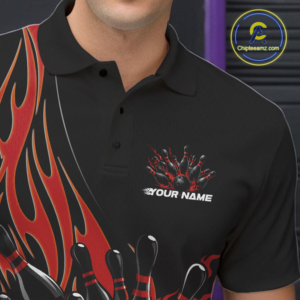 Close-up view of the left chest of a black bowling polo shirt showing red flaming black bowling ball striking pins detailed artwork.