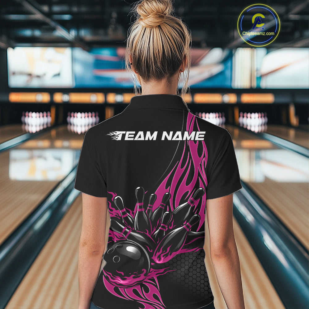 Back view female model at bowling lane wearing black quarter zip shirt with pink flaming bowling ball striking pins dynamic graphics