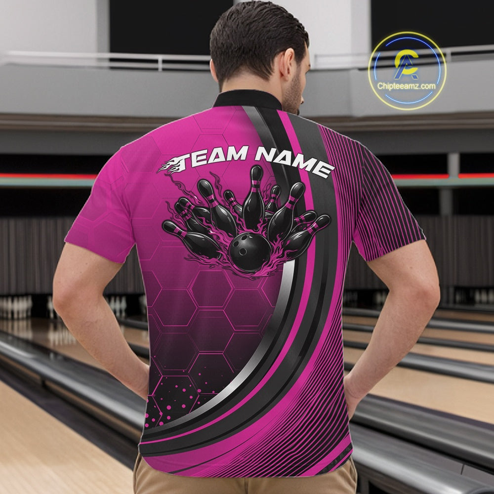 Male model in a bowling venue wearing a black and pink quarter zip shirt, showcasing honeycomb graphics with a fiery bowling ball striking pins.