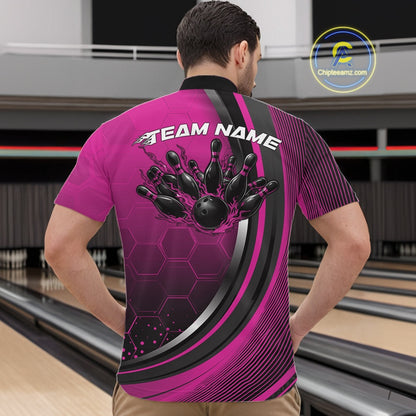 Male model in a bowling venue wearing a black and pink quarter zip shirt, showcasing honeycomb graphics with a fiery bowling ball striking pins.