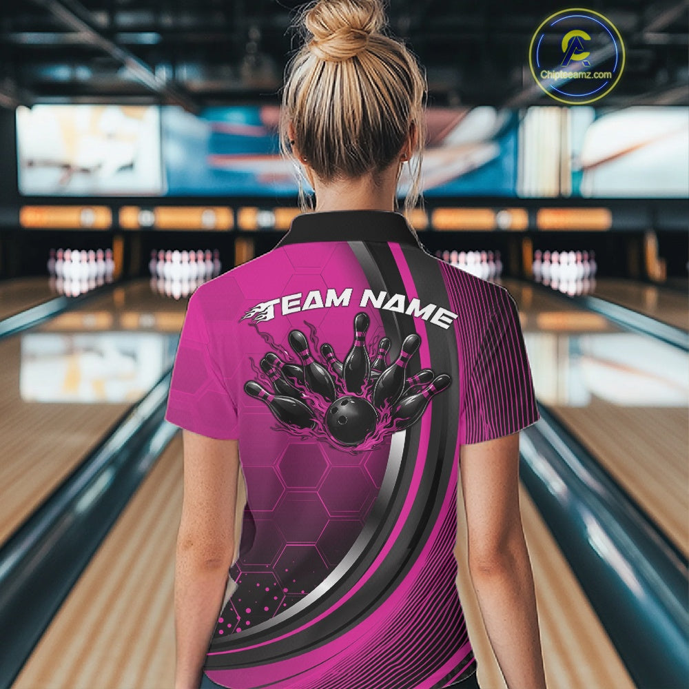 Back view of a female model wearing a black and pink bowling quarter zip with honeycomb accents and flaming bowling ball striking pins artwork in a bowling alley.