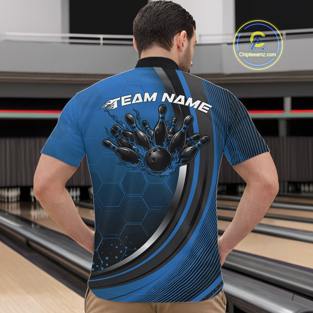 Male model at a bowling venue wearing a black and blue quarter zip shirt featuring honeycomb texture and a dynamic flaming bowling strike artwork.