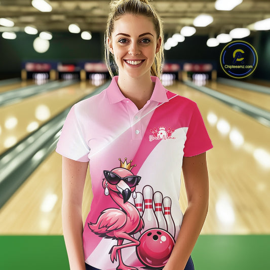 Female model at a bowling lane wearing a pink bowling polo shirt with a crowned flamingo in sunglasses and a bowling ball design.