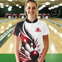 Load image into Gallery viewer, Front view of a female model wearing a white, black, and red bowling quarter zip shirt with a flaming bowling ball and pins illustration at a bowling lane.