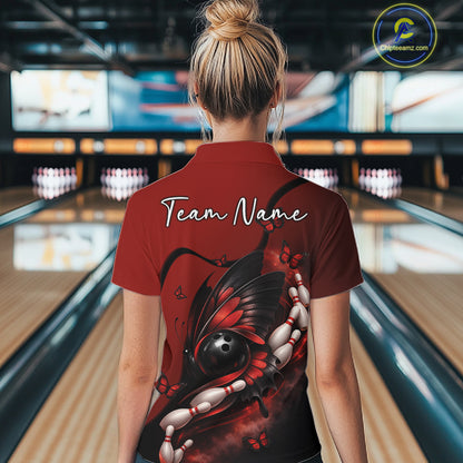 Back view of a female model in a bowling alley wearing a red and black quarter-zip shirt featuring a butterfly wrapped around a bowling ball.