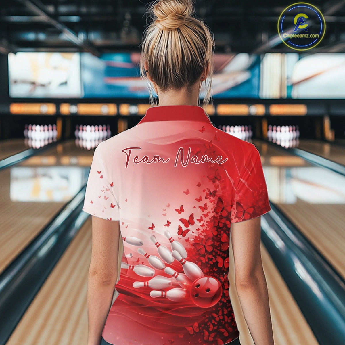 Female model in a white and red bowling quarter zip featuring butterfly graphics and bowling artwork, back view