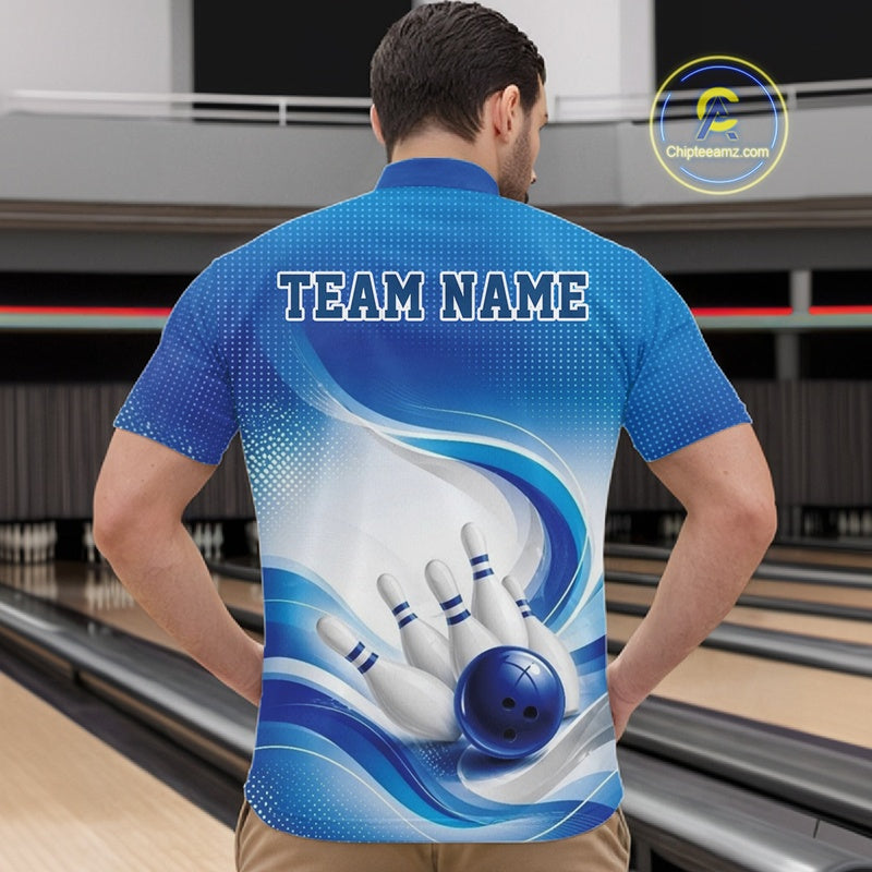 Male model standing in a bowling lane wearing a white and blue bowling quarter-zip shirt featuring abstract wave lines and a glossy bowling ball striking pins on the front.