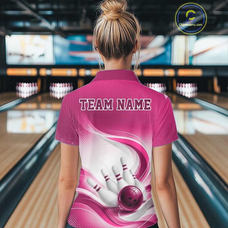 Womens white and pink bowling polo shirt shown from the back with dynamic wave graphics and a bowling strike design in a bowling alley