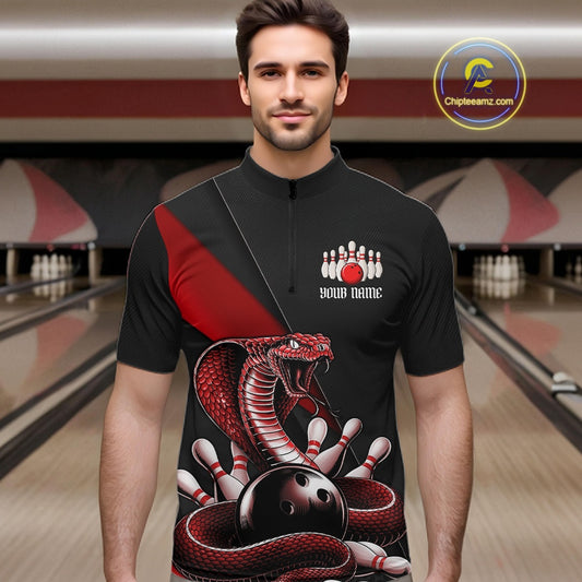 Male model at the bowling lane wearing a black quarter-zip with red cobra artwork and bowling-themed graphics.