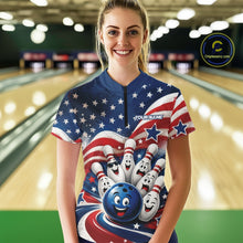 Load image into Gallery viewer, Front view of a female model wearing a bowling quarter zip shirt showcasing a funny bowling ball with cheerful animated pins, flowing American flag waves, and scattered stars in a bowling lane.
