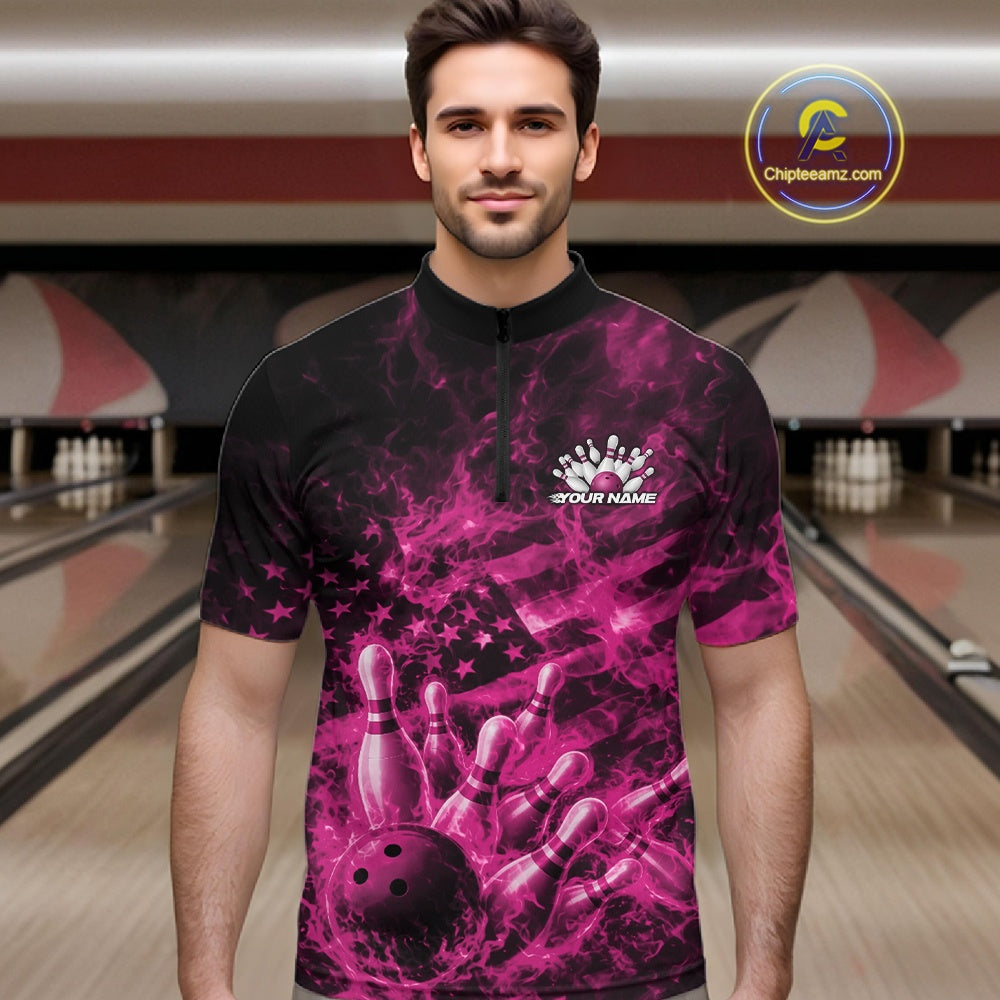 Male model at a bowling center wearing a black and pink quarter-zip decorated with patriotic bowling artwork and fiery details.