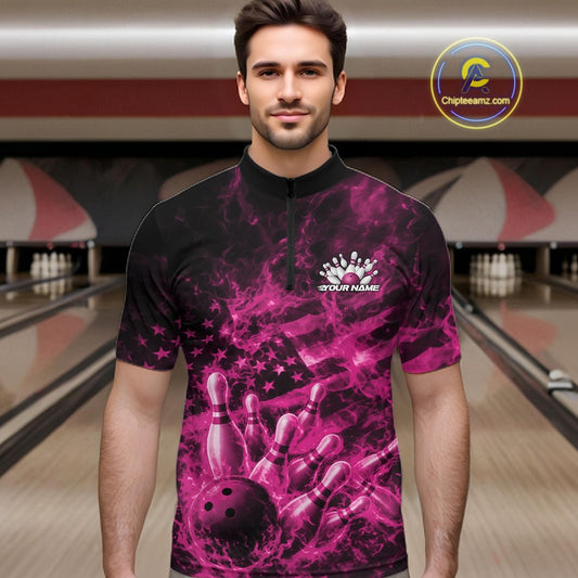 Male model at a bowling center wearing a black and pink quarter-zip decorated with patriotic bowling artwork and fiery details.