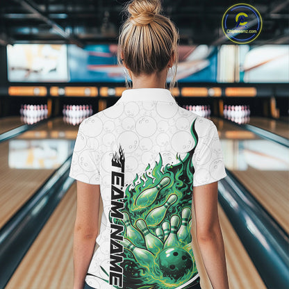 Back view female model in bowling lane wearing white and green quarter zip featuring flaming bowling ball crashing into pins with dynamic fiery bowling graphics.
