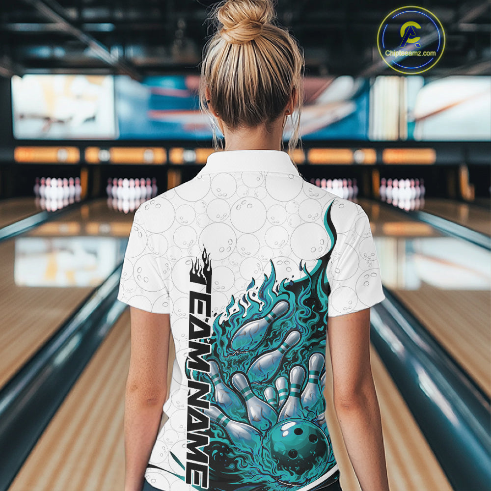 Back view female model in bowling lane wearing white and turquoise blue quarter zip featuring flaming bowling ball crashing into pins with dynamic fiery graphics.