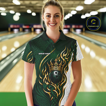 A woman stands in a bowling alley wearing a custom short-sleeve polo shirt with a green, gold, and white design featuring a crown, flame-like patterns, and a bowling ball graphic. 