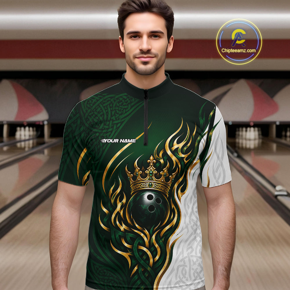 A man wearing a short-sleeve bowling-themed quarter-zip shirt with a dark green and white design featuring a gold crown and bowling ball graphic, set against a bowling alley background.