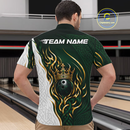 A man viewed from behind wearing a short-sleeve bowling shirt with a dark green and white tribal-style design, gold flame details, a crown, and a bowling ball graphic on the back. Bowling lanes are visible in the background.