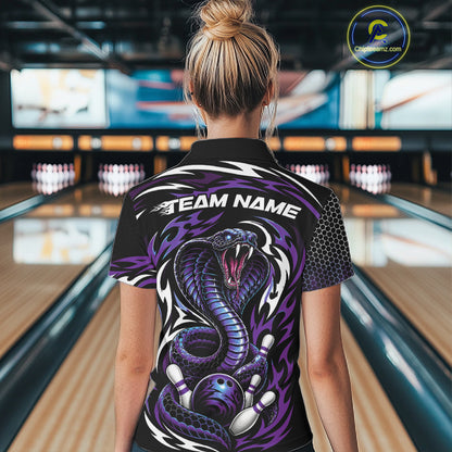 A woman viewed from behind wearing a black short-sleeve bowling polo shirt with a large purple and black snake graphic and the text 'TEAM NAME' across the upper back, standing in a bowling alley.