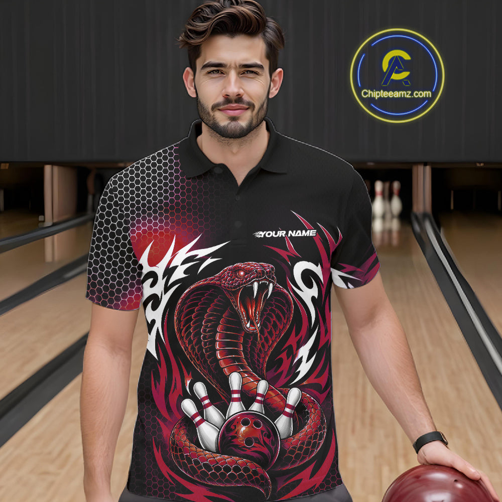 A man wearing a short-sleeve bowling polo shirt with a black and red cobra snake and bowling ball, bowling pins, standing in a bowling alley holding a bowling ball.