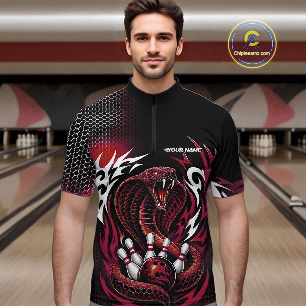 A man wearing a black short-sleeve bowling quarter zip shirt jersey with a red and black snake graphic, bowling pins, and tribal-style patterns, set against a blurred bowling alley background.
