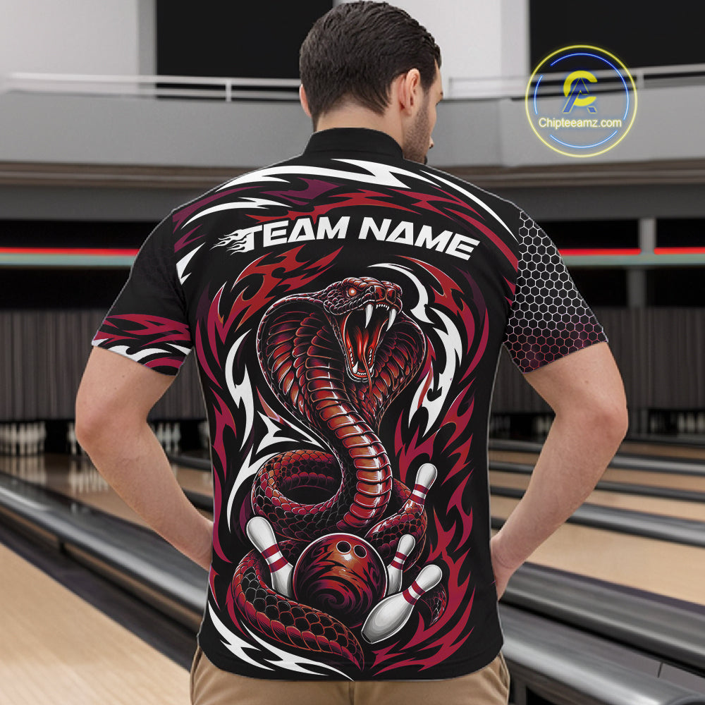 A man viewed from behind wearing a black short-sleeve bowling quarter zip shirt with a large red and white cobra snake graphic, flame motifs, and the text 'TEAM NAME' across the upper back. 