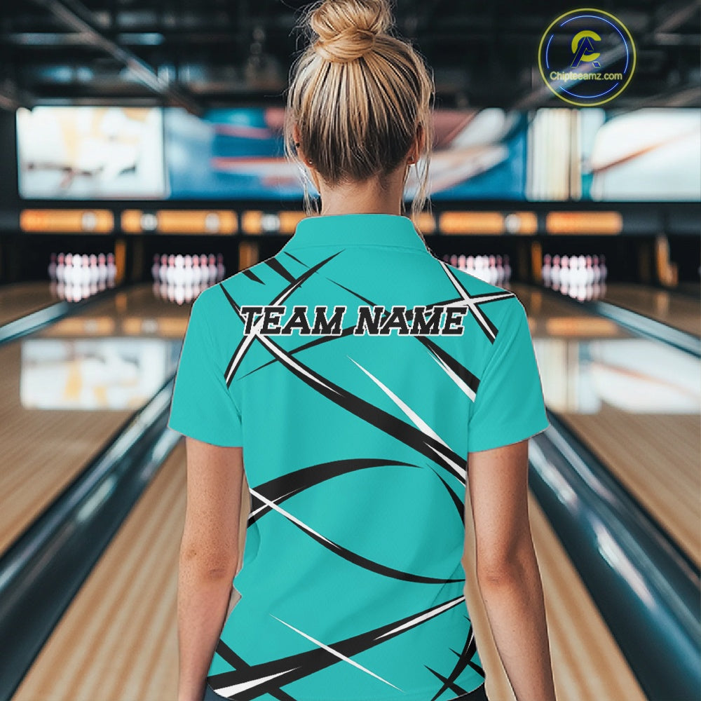 Back view of a female bowler in a bowling alley wearing a turquoise blue, black, and white bowling quarter zip shirt with an athletic jersey pattern