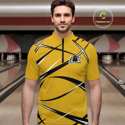Front view of a male bowler in a bowling lane wearing a yellow, black, and white bowling quarter zip shirt