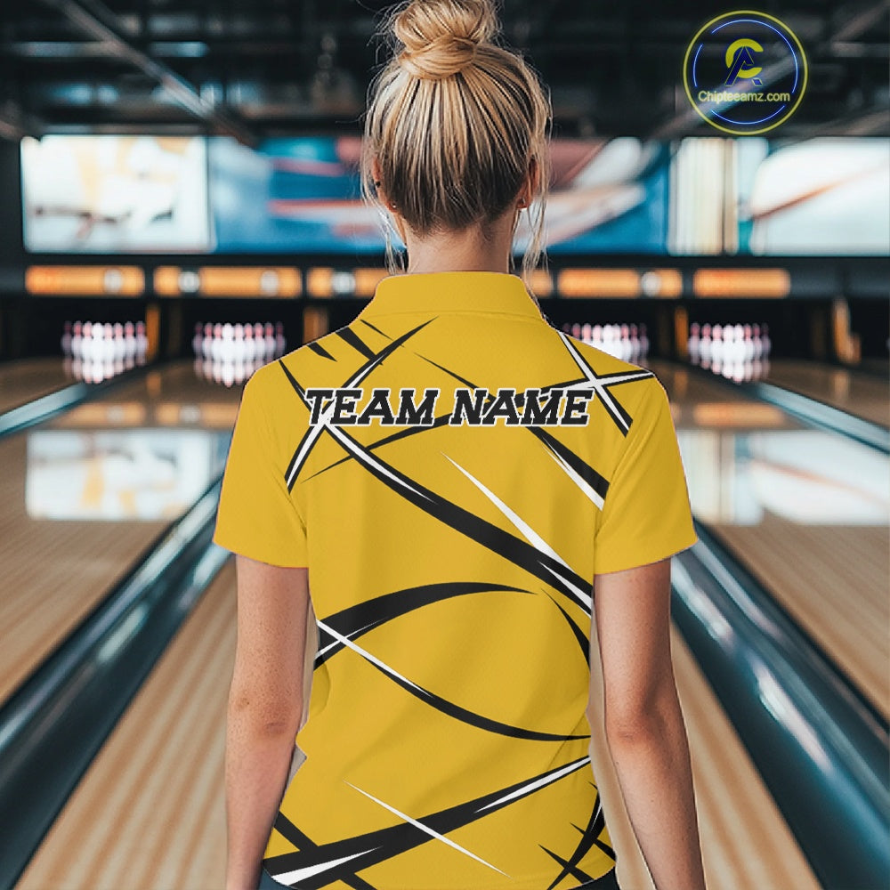 Back view of a female model wearing a yellow, black, and white bowling quarter zip shirt in a bowling alley