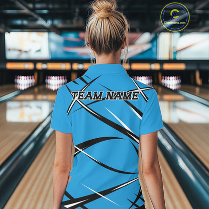 Back view of a female bowler in a bowling alley wearing a blue, black, and white bowling polo shirt with an athletic jersey pattern